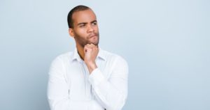 A man looking questioning about his bleeding gums and gum disease